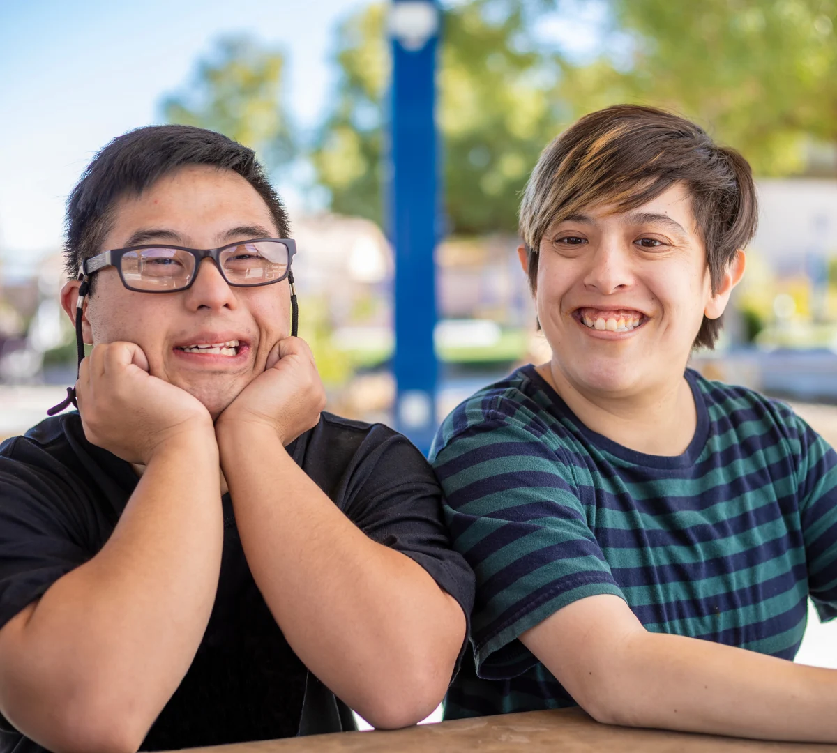 Two disabled friends smiling at camera