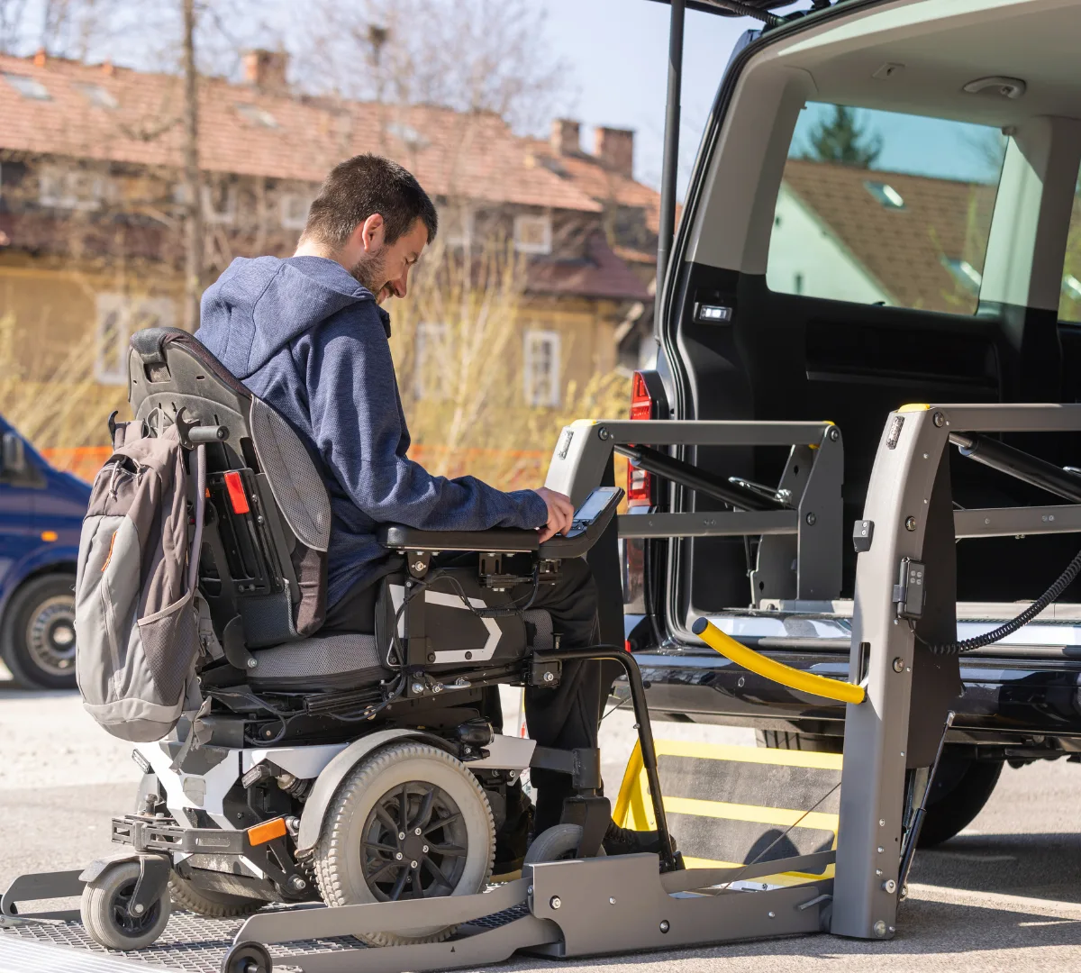 Disabled man in wheelchair getting into van