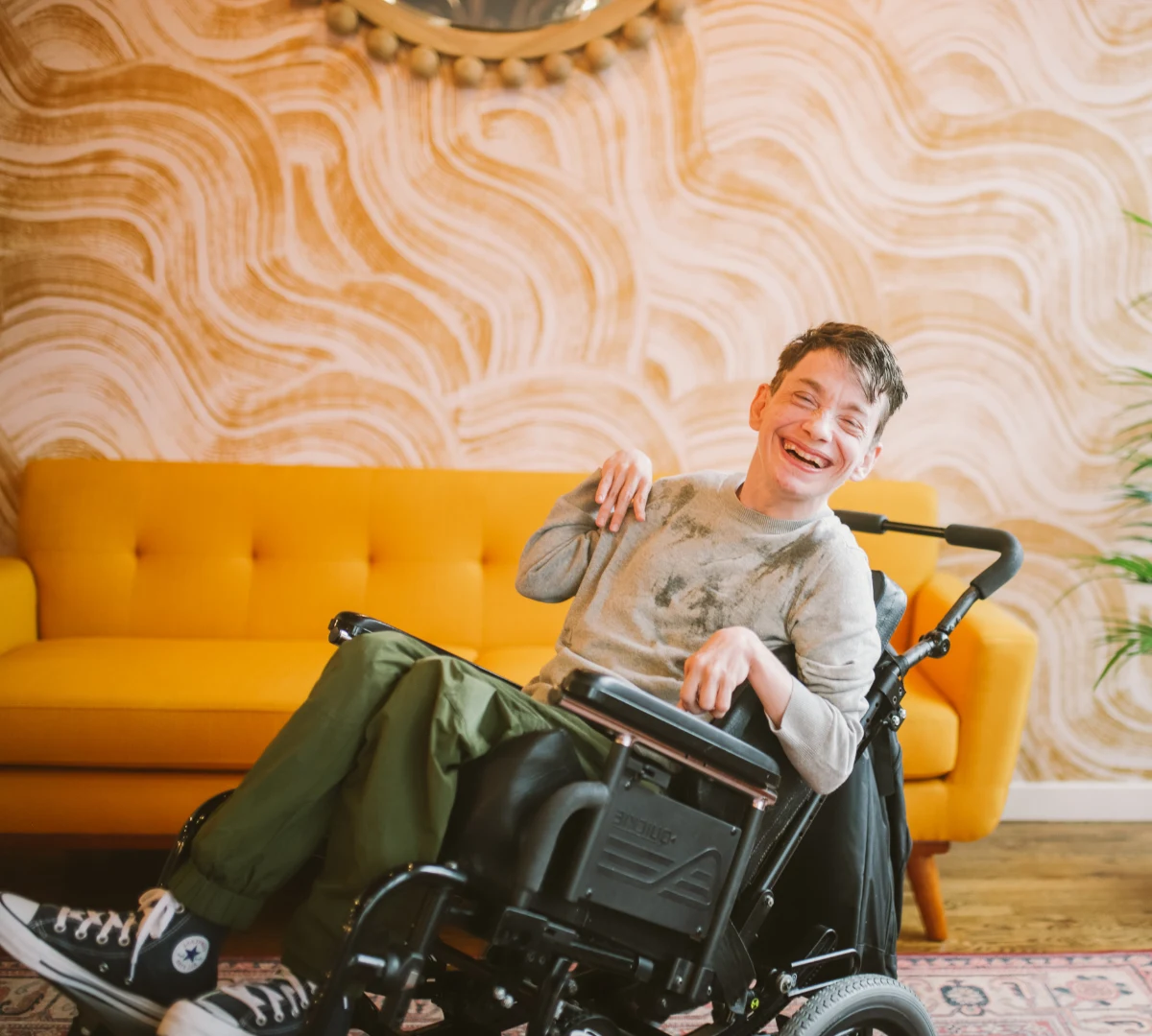 Disabled man in wheelchair smiling at camera