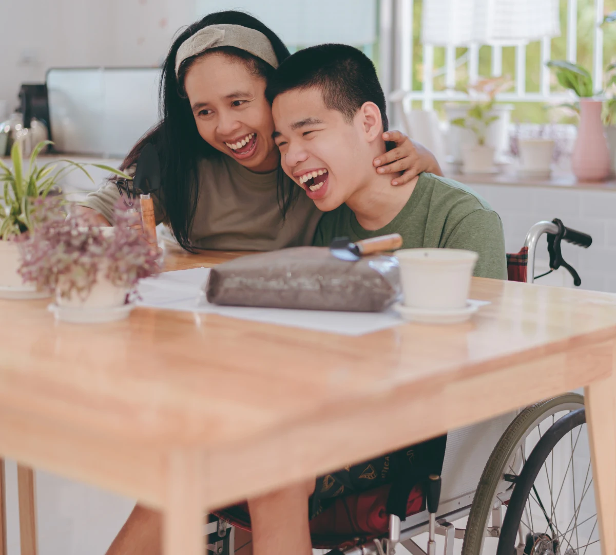 Happy mum with disabled boy in wheelchair