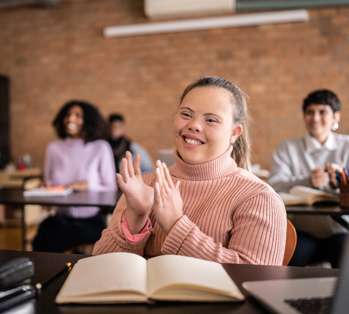 Smiling disabled woman with down syndrome in class