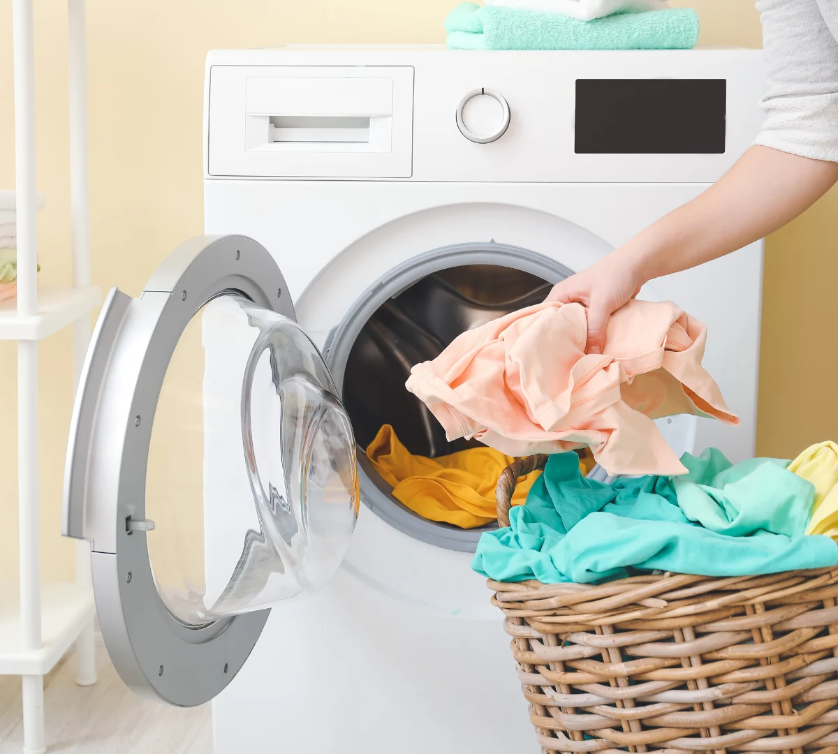 Woman putting washing in washing machine