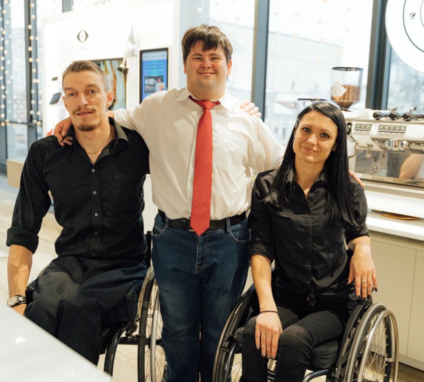 Disabled man at work with two friends